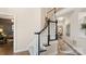 Open-concept staircase with carpeted steps and modern black and white railings, connecting seamlessly to the home's layout at 518 Streamside Ln, Marvin, NC 28173