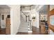 Elegant foyer showcasing a carpeted staircase with dark wood accents, complemented by hardwood floors and a decorative niche at 518 Streamside Ln, Marvin, NC 28173