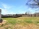 A spacious backyard is enclosed by a wooden fence, offering privacy and ample space for outdoor activities at 5810 Dove Point Sw Dr, Concord, NC 28025
