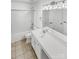 This bathroom features white cabinets, double sinks, large mirror and shower-tub combination at 5810 Dove Point Sw Dr, Concord, NC 28025