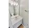 This bathroom has a white sink and vanity, a mirror, and modern lighting fixtures at 5810 Dove Point Sw Dr, Concord, NC 28025
