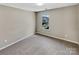 Comfortable bedroom bathed in soft light, featuring a scenic view at 5810 Dove Point Sw Dr, Concord, NC 28025