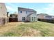 View of home exterior featuring sunroom and backyard at 5810 Dove Point Sw Dr, Concord, NC 28025
