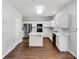 Modern kitchen with white cabinetry, stainless steel appliances, and an island at 5810 Dove Point Sw Dr, Concord, NC 28025