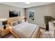 Relaxing bedroom with plush bedding, bedside tables, lamps, and a lovely window view at 5810 Dove Point Sw Dr, Concord, NC 28025