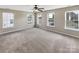 A spacious Primary bedroom with multiple windows and neutral carpet offering natural light at 5810 Dove Point Sw Dr, Concord, NC 28025
