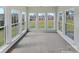 Light-filled sunroom featuring large windows with views of the backyard and garden at 5810 Dove Point Sw Dr, Concord, NC 28025