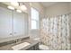 Bathroom with granite countertop vanity, toilet, and shower with playful llama-themed curtain at 6016 Dogwood Blvd, Kannapolis, NC 28081