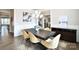 Open-concept dining area with hardwood floors, modern lighting, and seamless flow to other living spaces at 6016 Dogwood Blvd, Kannapolis, NC 28081