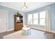 Cozy dining room featuring a large window, light blue walls, and a decorative china cabinet at 6016 Dogwood Blvd, Kannapolis, NC 28081