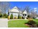 Beautifully landscaped front yard and partial view of the home's facade on a sunny day at 6016 Dogwood Blvd, Kannapolis, NC 28081