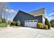 Spacious two-car garage with ample driveway space, surrounded by lush landscaping and mature trees at 6016 Dogwood Blvd, Kannapolis, NC 28081