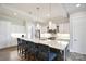 Modern kitchen featuring a large island with a sink and seating, stainless steel appliances, and white cabinetry at 6016 Dogwood Blvd, Kannapolis, NC 28081