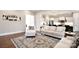 Open-concept living space with a view of the kitchen, hardwood floors and neutral furniture at 6016 Dogwood Blvd, Kannapolis, NC 28081