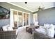 Relaxing screened-in porch with comfortable seating, an outdoor TV and plenty of natural light at 6016 Dogwood Blvd, Kannapolis, NC 28081