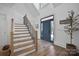 Bright foyer with staircase, hardwood floors, and a stylish front door at 607 Beaten Path Rd, Mooresville, NC 28117