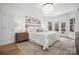 Serene main bedroom with a plush bed, soft lighting, hardwood floors, and outdoor views at 607 Beaten Path Rd, Mooresville, NC 28117