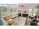 Sun-filled living room features modern furniture, a fireplace, and large windows that provide plenty of natural light at 7015 Sylvan Retreat Dr, Denver, NC 28037
