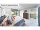 The room showcases a large window with a backyard view and leads to an open loft area at 7021 Sylvan Retreat Dr, Denver, NC 28037