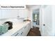 Well-appointed butler's pantry with white cabinets and direct access to dining room at 7021 Sylvan Retreat Dr, Denver, NC 28037