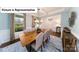 Bright dining room with a modern chandelier, large window, and a stylish area rug at 7021 Sylvan Retreat Dr, Denver, NC 28037