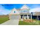 Charming two-story home featuring stone accents, a covered front porch, and a well-manicured lawn at 7021 Sylvan Retreat Dr, Denver, NC 28037