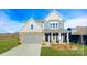 Charming two-story home with a manicured lawn, stone accents, and a welcoming front porch at 7021 Sylvan Retreat Dr, Denver, NC 28037