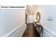 Inviting foyer with hardwood floors, wainscoting, and a decorative mirror above a console table at 7021 Sylvan Retreat Dr, Denver, NC 28037