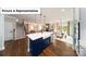Open-concept kitchen featuring a large island with a farmhouse sink, stainless steel appliances, and hardwood floors at 7021 Sylvan Retreat Dr, Denver, NC 28037