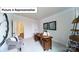 Well-lit home office with a large desk, neutral colors, and modern decor at 7021 Sylvan Retreat Dr, Denver, NC 28037