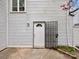 Back door of the home with gray horizontal siding at 7415 Mystic Ln, Charlotte, NC 28227