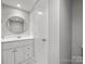 Modern bathroom featuring white cabinetry, a round mirror, and recessed lighting at 7415 Mystic Ln, Charlotte, NC 28227