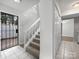 Entryway featuring tile floor, staircase, closet, and secure front door with metal bars at 7415 Mystic Ln, Charlotte, NC 28227