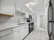 Bright kitchen with a stainless steel sink, sleek black appliances, and ample counter space at 7415 Mystic Ln, Charlotte, NC 28227