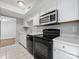 Kitchen featuring ample counter space, stainless steel microwave, and black appliances at 7415 Mystic Ln, Charlotte, NC 28227