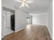 Open-concept living room with wood floors, and access to a refrigerator and backyard at 7415 Mystic Ln, Charlotte, NC 28227