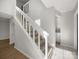 Carpeted staircase with white railing and ample natural light from a high window at 7415 Mystic Ln, Charlotte, NC 28227