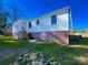 Exterior home view with white siding, brick foundation and green lawn at 826 E Alexander St, Lincolnton, NC 28092