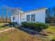 Charming single-story home with white siding, walkway, and landscaped front yard under a clear blue sky at 826 E Alexander St, Lincolnton, NC 28092