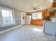Functional kitchen with ample cabinet space, white appliances, and tiled floor at 826 E Alexander St, Lincolnton, NC 28092