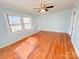 Bright living room featuring hardwood floors, a ceiling fan, and light blue walls at 826 E Alexander St, Lincolnton, NC 28092