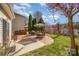 Backyard featuring brick patio with outdoor seating surrounded by greenery at 9018 Seamill Rd, Charlotte, NC 28278