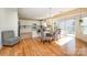Dining area featuring hardwood floors, a dining table set, and sliding glass doors at 9018 Seamill Rd, Charlotte, NC 28278