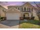 Inviting two-story home with a well-manicured lawn and blossoming tree at 9018 Seamill Rd, Charlotte, NC 28278