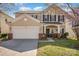Inviting two-story home with a well-manicured lawn and blossoming tree at 9018 Seamill Rd, Charlotte, NC 28278