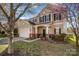 Charming two-story home featuring a manicured lawn and blossoming trees at 9018 Seamill Rd, Charlotte, NC 28278