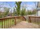 Inviting back deck offers private outdoor relaxation with a fenced lawn and verdant trees beyond at 98 Ring Sw Ave, Concord, NC 28025