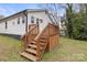 The back of the house features a charming deck with wooden stairs and a cozy backyard at 98 Ring Sw Ave, Concord, NC 28025