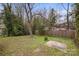 Spacious backyard with a concrete pad and wood fence, providing privacy and space at 98 Ring Sw Ave, Concord, NC 28025