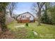 Lawn with a cozy deck, offering a harmonious balance of natural beauty and outdoor living space at 98 Ring Sw Ave, Concord, NC 28025